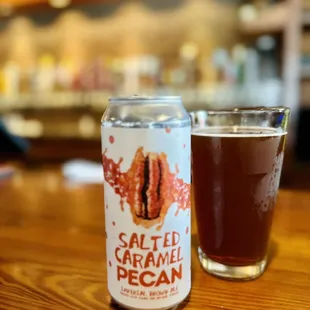 a can of salted caramel pecan next to a glass of beer