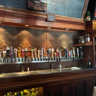 a row of beer taps on a bar