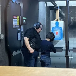 Carol teaching my grandson gun safety.