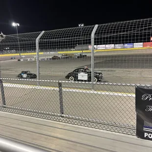 Old cop car behind the pace car before a race.