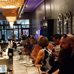 a group of people sitting at a bar