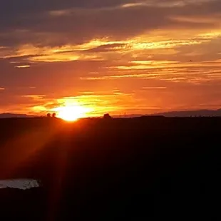 Sunset from the bungalow ' s large deck. Lovely accommodations tastefully decorated.