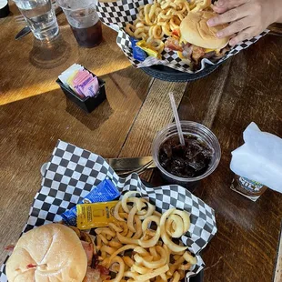 a person eating a sandwich and fries