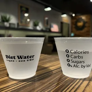 two plastic cups on a table