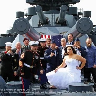 a bride and groom posing on a battleship