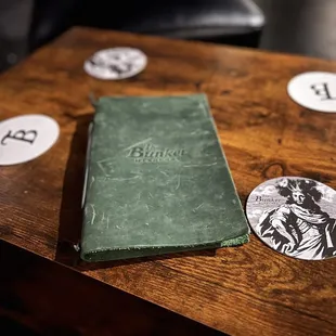 a green book on a wooden table