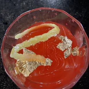 a glass filled with liquid and garnish