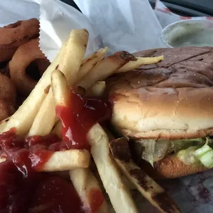 Cheeseburger with grilled onions, fries and extra order of onion rings.
