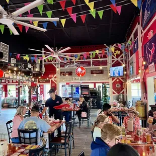 people sitting at tables in a restaurant