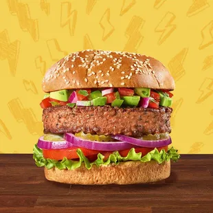 a hamburger with lettuce, tomatoes, and onions