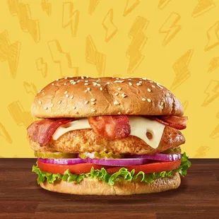 a chicken sandwich with lettuce, tomato, and cheese