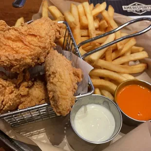 a basket of fried chicken and french fries