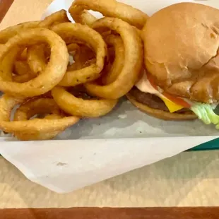 a basket of onion rings and a burger