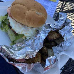 Mushroom Swiss burger with bacon &amp; a fried egg. Also had garlic potato wedges