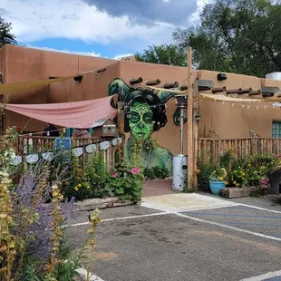 View from the parking lot on the side of the building. Outdoor seating is at left