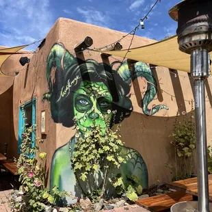 a woman painted on the side of a building