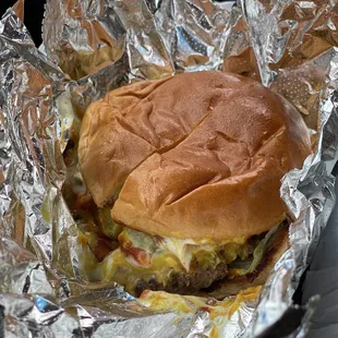 a hamburger wrapped in aluminum foil