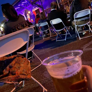 a person holding a glass of beer