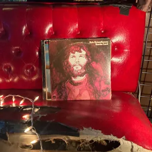 a picture of a man on a red couch