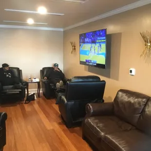 two men sitting in recliners in a living room