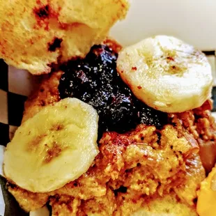 a plate of food with a sandwich and banana slices