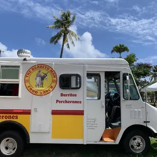 a food truck parked on the grass