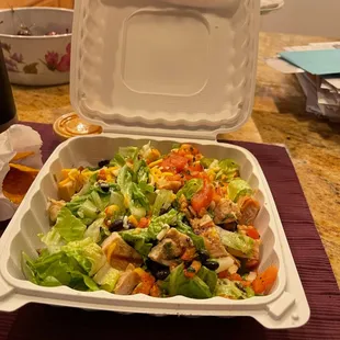 a salad in a styrofoam container