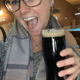 a woman holding a glass of beer