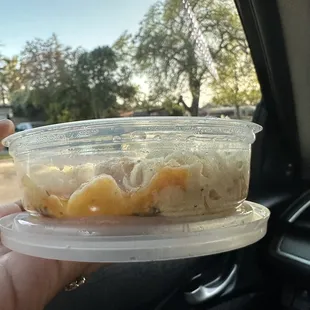 the smallest mac n cheese container i've ever seen in my life (as big as my first pinky joint) &amp; wasn't even filled all the way