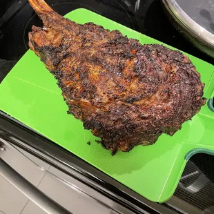 Prime Tomahawk Steak covered in a layer of mustard and a layer of Montreal Steak Spice.