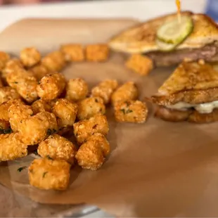 a sandwich and tater tots