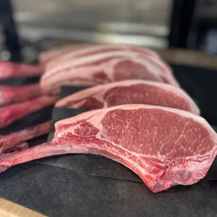 raw steaks on a cutting board