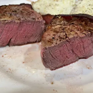 two steaks on a white plate