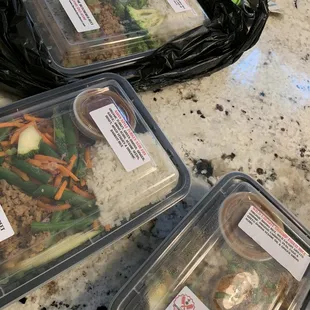 three plastic containers of food