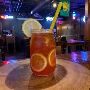 a glass of iced tea with a lemon slice