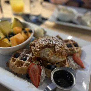 a plate of waffles and fruit