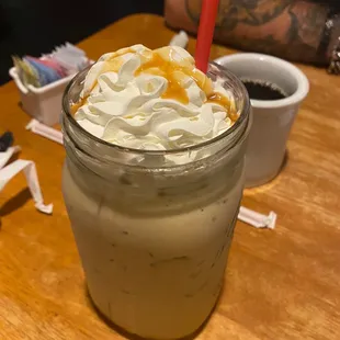 a drink with whipped cream and caramel