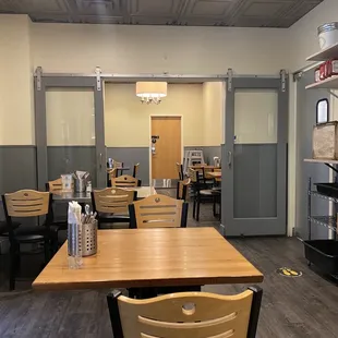 a dining area with tables and chairs