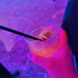 a person holding a drink