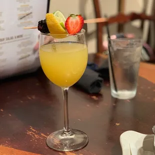 a cocktail with a strawberries garnish