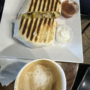 Mexican egg wrap with chicken. Breve coffee with rose.