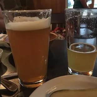 a plate of food and a glass of beer