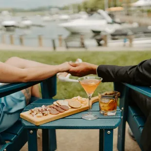 a man and a woman sitting at a table holding hands