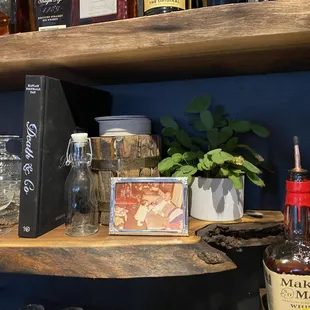 a shelf of liquor bottles and glasses