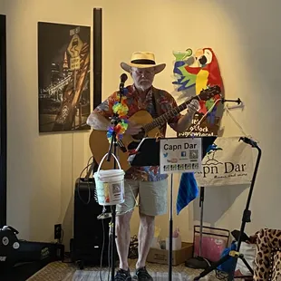 a man in a hat playing a guitar