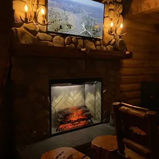Cozy fireplace with TV above