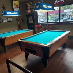 two pool tables and a bar