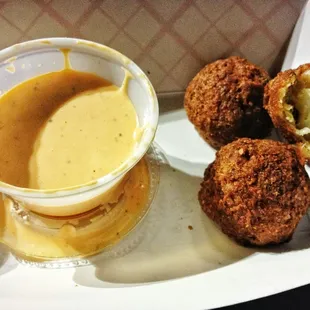 Crab Ballz in spicy dipping sauce.