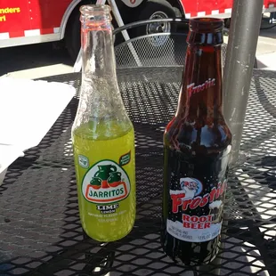 two bottles of soda on a table