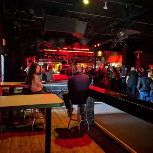 people sitting at tables in a bar
